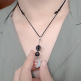 Touching lava stone of Tactile Necklace to get some essential oil on your fingers